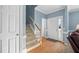 Welcoming foyer with hardwood floors, staircase, and natural light streaming through the front door at 3648 Praed Pl, Fuquay Varina, NC 27526
