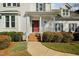 Close up of the red front door and entry porch with brick steps and white columns at 3648 Praed Pl, Fuquay Varina, NC 27526