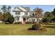 Traditional two-story home with landscaped front yard and charming red front door at 3648 Praed Pl, Fuquay Varina, NC 27526