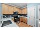 Modern kitchen featuring stainless steel appliances, light wood cabinets, and dark backsplash tiles at 3648 Praed Pl, Fuquay Varina, NC 27526