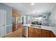 Kitchen showcases stainless steel refrigerator, white countertops, light wood cabinets, and an adjacent dining area at 3648 Praed Pl, Fuquay Varina, NC 27526