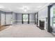 Spacious living room with natural light, a ceiling fan, and a cozy fireplace at 3648 Praed Pl, Fuquay Varina, NC 27526