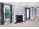 Light-filled living room featuring a fireplace with decorative tile surround and built-in shelving at 3648 Praed Pl, Fuquay Varina, NC 27526