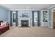 Bright living room with a fireplace, built-in shelving, and large windows at 3648 Praed Pl, Fuquay Varina, NC 27526