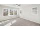 Bright bedroom featuring large windows and neutral carpet at 4501 Mint Leaf Ln, Raleigh, NC 27612