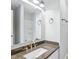 Bathroom vanity features granite counters, modern fixtures, and an updated mirror at 4523 Hamptonshire Dr, Raleigh, NC 27613