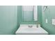 Simple bathroom featuring a white sink and vanity, neutral walls, and a minimalist aesthetic at 4523 Hamptonshire Dr, Raleigh, NC 27613