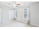 Bedroom with carpet, ceiling fan, two closets and bright windows dressed in sheer curtains at 4523 Hamptonshire Dr, Raleigh, NC 27613