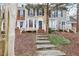 Charming townhomes with brick and siding exteriors and well-maintained front lawns and landscaped front yard at 4523 Hamptonshire Dr, Raleigh, NC 27613