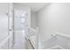 Neutral hallway with white railing, open bedroom doorway and carpet at 4523 Hamptonshire Dr, Raleigh, NC 27613