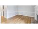 Spacious living room featuring hardwood floors, chair railing and a glimpse into the adjacent kitchen at 4523 Hamptonshire Dr, Raleigh, NC 27613