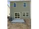 Exterior home view showcases a green vinyl siding, and a gray concrete patio with a sliding glass door entrance at 46 Shay St, Angier, NC 27501