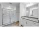 Modern bathroom with a glass shower and vanity with granite countertop at 46 Shay St, Angier, NC 27501