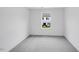 Neutral bedroom boasts plush carpeting, a large window and neutral walls at 46 Shay St, Angier, NC 27501