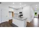 Bright kitchen features white cabinets, stainless steel appliances, and granite countertops at 46 Shay St, Angier, NC 27501