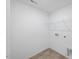 A simple laundry room with white walls, neutral floors, and functional wire shelving for storage at 46 Shay St, Angier, NC 27501