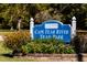 Sign for Cape Fear River Trail Park surrounded by green plants, flowers, and landscaping at 46 Shay St, Angier, NC 27501