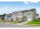 Charming row of modern townhomes featuring a variety of exterior colors, landscaping, and attached garages at 46 Shay St, Angier, NC 27501
