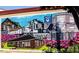 Colorful brick wall mural featuring the town's history with train and buildings at 46 Shay St, Angier, NC 27501