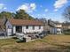 Spacious backyard with a patio, lush lawn, and mature trees at 47 Angela Way, Durham, NC 27703