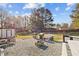 Large backyard with an outdoor patio, grilling area, and trees at 47 Angela Way, Durham, NC 27703