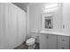 Modern bathroom featuring a shower with white curtain, a white vanity, and a mirrored cabinet at 47 Angela Way, Durham, NC 27703