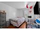 A bedroom with laminate floors, bed, dresser and a crib at 47 Angela Way, Durham, NC 27703