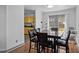 Dining area with a wooden table set, leading to a view of the backyard and a glimpse of the yellow kitchen at 47 Angela Way, Durham, NC 27703