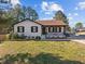 Charming single-story home with black trim, a covered porch, and a well-maintained front lawn at 47 Angela Way, Durham, NC 27703