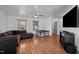 Bright living room features modern ceilings fan, wood-look floors, a large couch, and large windows at 47 Angela Way, Durham, NC 27703