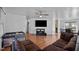 Open-concept layout with a large couch, entertainment center, and seamless transition to the dining area at 47 Angela Way, Durham, NC 27703