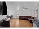 Bright living room showcasing wood-look floors, a large couch, modern light fixtures, and large windows at 47 Angela Way, Durham, NC 27703