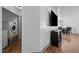 Spacious living area featuring sleek floors, a television, and a modern washer and dryer combo at 47 Angela Way, Durham, NC 27703