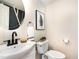 Stylish powder room featuring a vessel sink, modern fixtures, and decorative mirror at 5 Bridgeport Dr, Durham, NC 27713