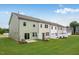 Backyard featuring green space and sliding glass doors to patios at 52 Shay St, Angier, NC 27501