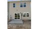 View of the home's rear exterior with a concrete patio and sliding glass door access at 52 Shay St, Angier, NC 27501