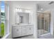 The full bathroom features a double vanity and a walk-in shower with glass door at 52 Shay St, Angier, NC 27501