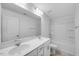 Bathroom featuring double sinks, chrome fixtures, and combination shower and tub at 52 Shay St, Angier, NC 27501