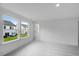 Bright bedroom with two large windows showing the exterior yard and new carpet at 52 Shay St, Angier, NC 27501