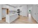 Bright, open kitchen with white cabinets, stainless steel appliances and a view to the entrance at 52 Shay St, Angier, NC 27501