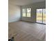 Bright living room with large windows and sliding glass doors leading to a patio area at 52 Shay St, Angier, NC 27501