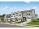 Street view of new construction townhomes featuring attached garages and diverse color schemes at 52 Shay St, Angier, NC 27501