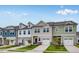 Street view of new construction townhomes featuring attached garages and diverse color schemes at 52 Shay St, Angier, NC 27501