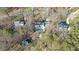 A high-angle aerial view of an estate featuring mature trees and a stunning backyard pool area at 5317 Chimney Swift Dr, Wake Forest, NC 27587