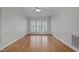 Clean, empty bedroom featuring hardwood floors and a large window with shutters at 5317 Chimney Swift Dr, Wake Forest, NC 27587