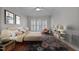Well-lit bedroom with hardwood floors, neutral walls, and a large window at 5317 Chimney Swift Dr, Wake Forest, NC 27587