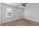 This bedroom has neutral walls, carpet, and a ceiling fan with plenty of natural light from two windows at 5317 Chimney Swift Dr, Wake Forest, NC 27587