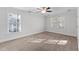 A well-lit bedroom with carpet flooring and two windows for ample natural light at 5317 Chimney Swift Dr, Wake Forest, NC 27587