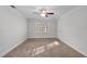 A well-lit bedroom featuring crown moulding, a ceiling fan, and neutral carpeting at 5317 Chimney Swift Dr, Wake Forest, NC 27587