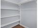 Bright, walk-in closet with shelving and hanging rods for organization at 5317 Chimney Swift Dr, Wake Forest, NC 27587